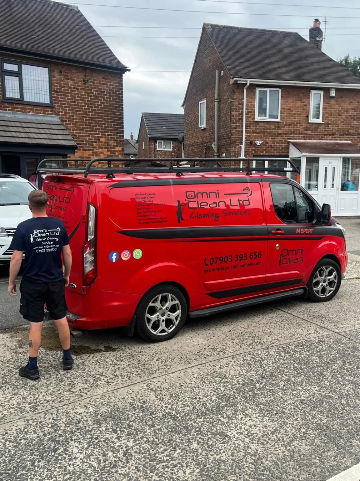 Omni Clean window cleaner beside the company van on a residential street in Wythenshawe