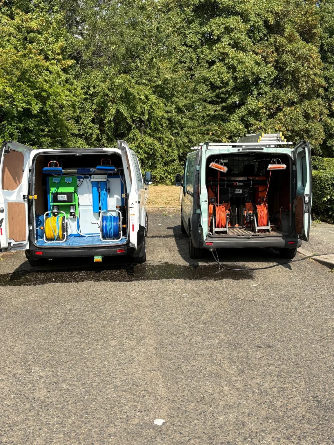Two Omni Clean vans fitted with water-fed pole reach and wash systems